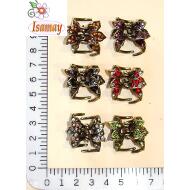 PINZA BRONCE PEQUEÑA FLOR CENTRAL PICOS STRASS COLORES